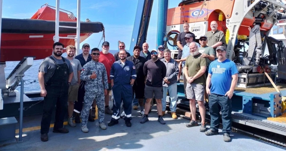 The 2023 and 2024 discovery team on deck beside the ROV